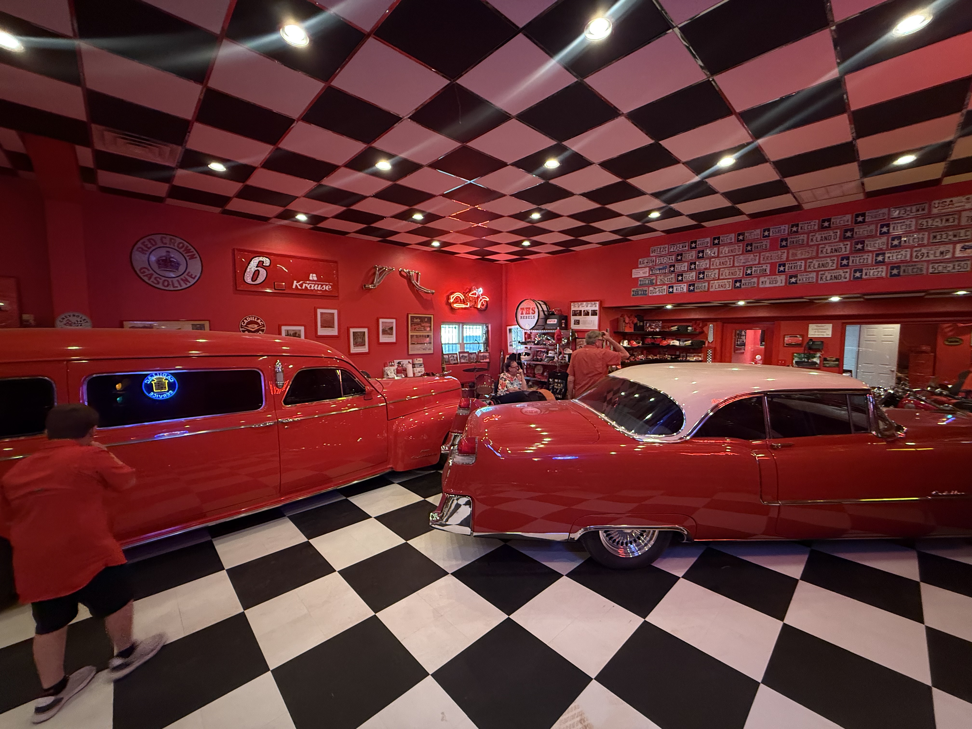 Two red classic Cadillacs inside Billy Krause’s red checkerboard garage